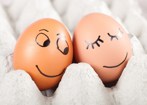 two funny smiling eggs in a packet - Foto, afbeelding