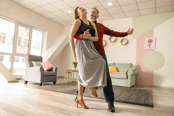 Happy mature couple dancing at home - Фото, зображення