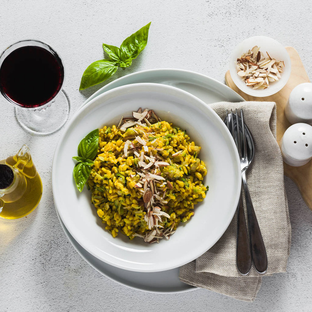 risotto with zucchini and turmeric or saffron in a plate on the table. healthy italian food - Photo, Image