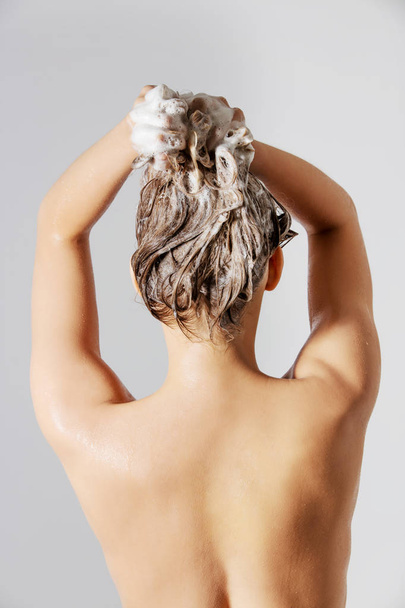 Woman washing her blond hair - Foto, imagen