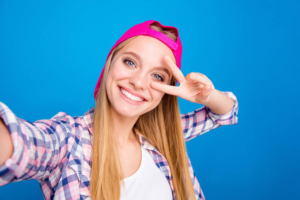 Peace Young woman in hat and shirt making a selfie on the camer - Photo, image