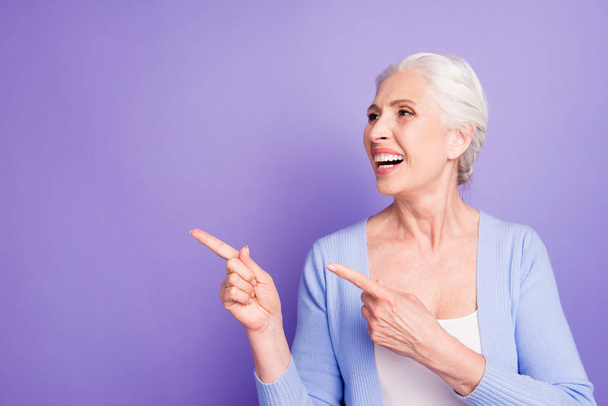 Grey haired old nice beautiful smiling woman pointing with two f - Foto, immagini