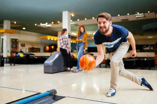 Handsome man throwing bowling ball - Foto, immagini
