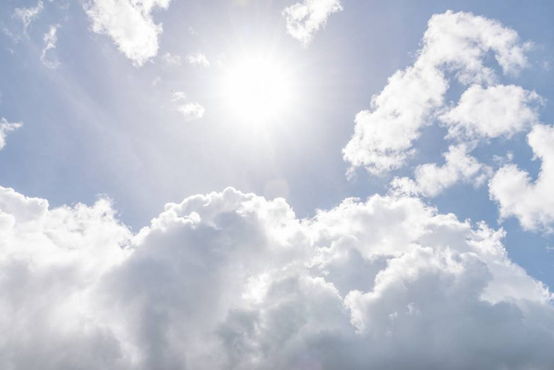Вид на блакитне небо з сонцем і хмарами
 - Фото, зображення