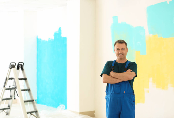 Pintor masculino em uniforme dentro de casa
 - Foto, Imagem