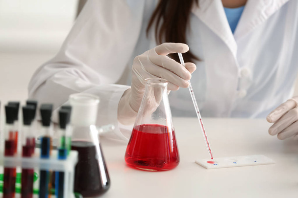Female scientist working in laboratory, closeup - Фото, изображение