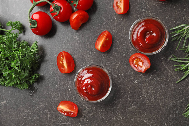 Composition with tasty tomato sauce on grey background - Foto, imagen