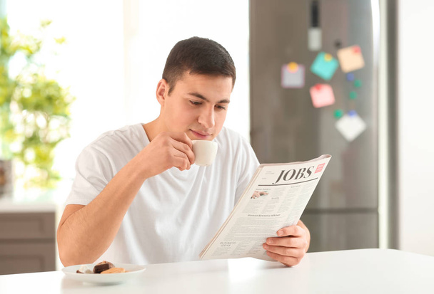 Man reading morning newspaper during breakfast at home - Фото, зображення