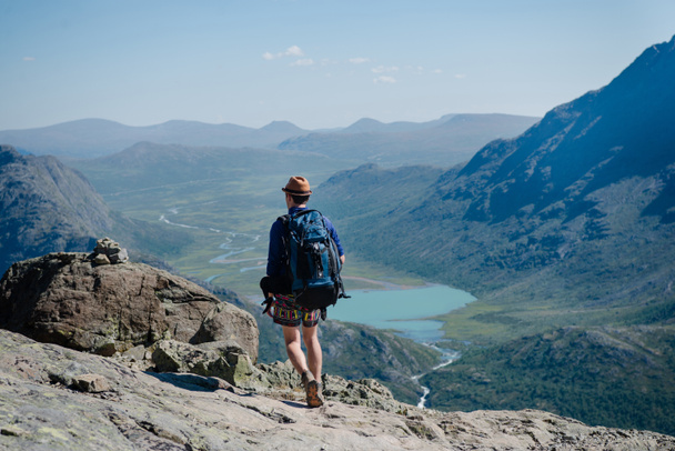 man hiking on Besseggen ridge over Gjende lake in Jotunheimen National Park, Norway  - Photo, Image