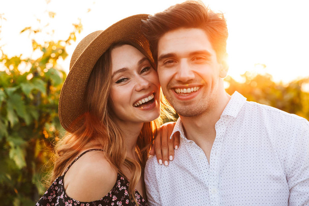 Photo of young cute happy loving couple outdoors looking camera. - Фото, зображення