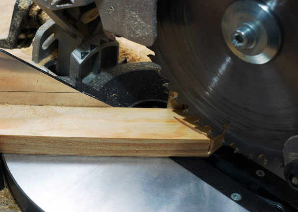 Carpenter tools on wooden table with sawdust. Circular Saw. Cutting a wooden plank - Foto, Bild