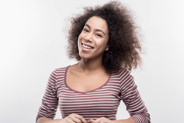 Good-looking beaming curly woman feeling extremely happy and cheerful - Фото, зображення