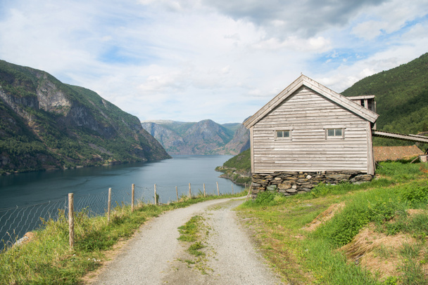 vidéki road és a fából készült ház fenséges Aurlandsfjord, Flam (Aurlandsfjorden), Norvégia - Fotó, kép