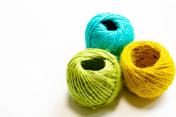 Set of yellowish green, orange and blue hemp threads isolated on white color background. Colorful Tones, Flat lay. copy space for your text - Zdjęcie, obraz