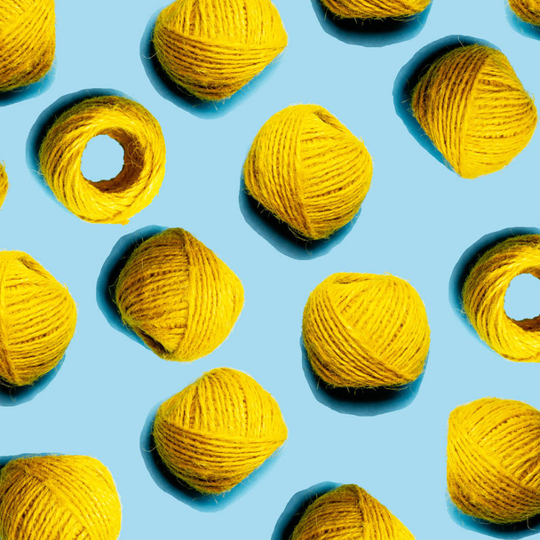 Set of yellow hemp threads isolated on blue color background. Colorful Tones, Flat lay. copy space for your text - Zdjęcie, obraz
