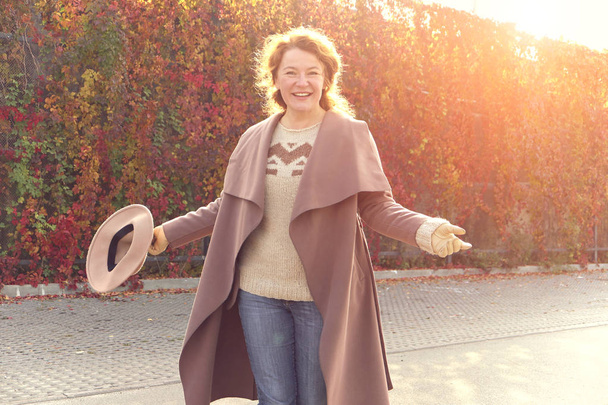 Very happy woman walks in the autumn day. - Fotó, kép