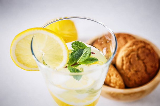 close up of glass of homemade lemonade and oatmeal cookies - 写真・画像