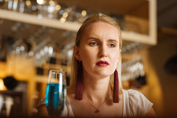 Sad gloomy young woman drinking alcohol alone - Valokuva, kuva