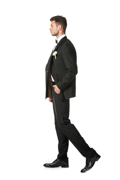side view of handsome young groom in stylish suit isolated on white - Foto, Imagen