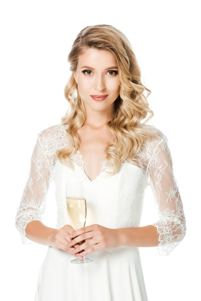 happy young bride with glass of champagne looking at camera isolated on white - Foto, imagen