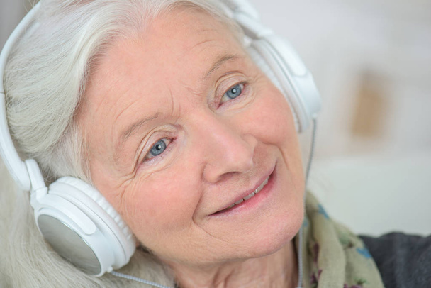 friendly old lady listening music - Фото, изображение