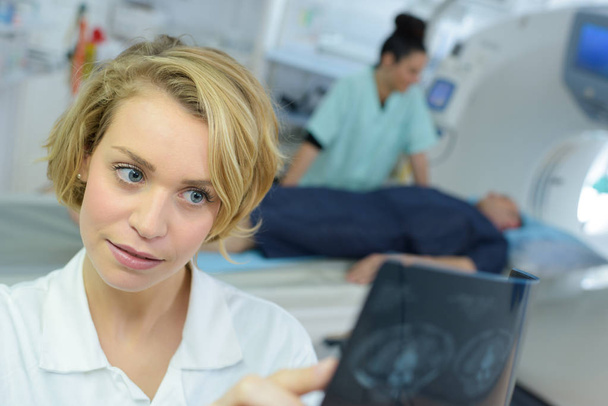 female specialist checking brain tomography results - Foto, Bild