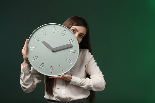 Woman with clock on color background. Time management concept - Photo, Image