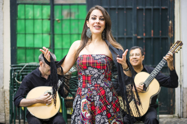 Fado band performing traditional portuguese music on the square of Alfama, Lisbon, Portugal - 写真・画像