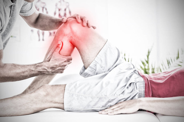 Highlighted pain against male physical therapist massaging patient calf muscle - Foto, Imagen