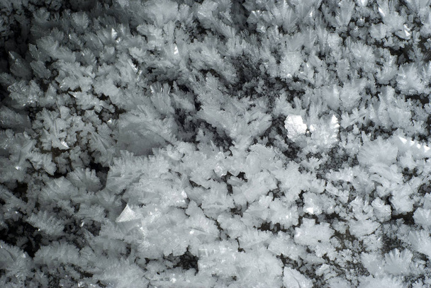 background: a section of the cave wall covered with large crystals of ic - Photo, Image