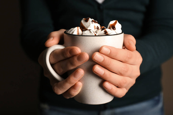 Woman holding cup of hot chocolate with marshmallows, closeup - Fotó, kép