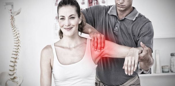 Highlighted pain against doctor examining female patient arm - Φωτογραφία, εικόνα