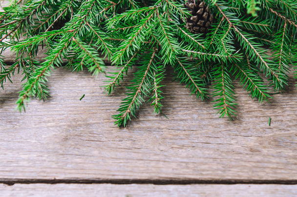 A bunch of green branches young spruce on a wooden table. Background. - 写真・画像