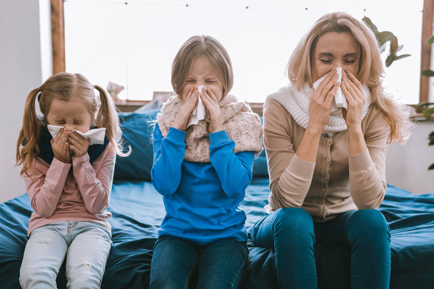 Unhappy cheerless family sneezing - Фото, изображение