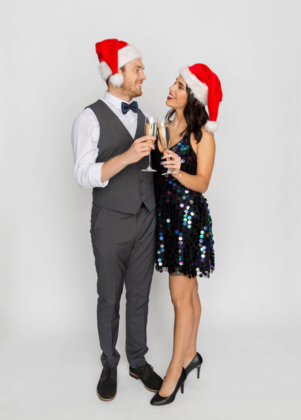 couple with champagne glasses at christmas party - Foto, Imagen