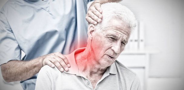 Highlighted pain against physiotherapist giving physical therapy to senior patient - Fotografie, Obrázek