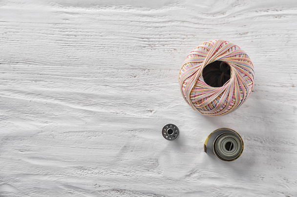 Sewing accessories on white wooden background - Fotografie, Obrázek