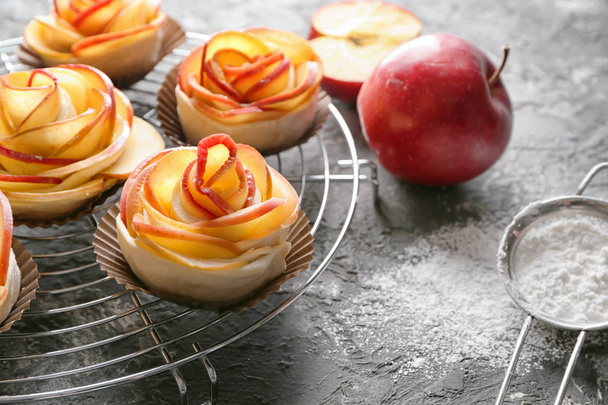 Rack with raw rose shaped apple pastry on table - Photo, image