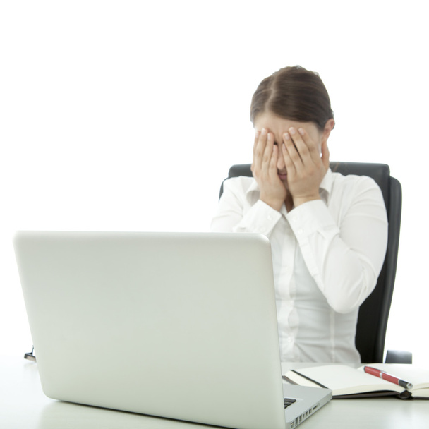 young beautiful brunette woman is depressed on desk - Фото, изображение