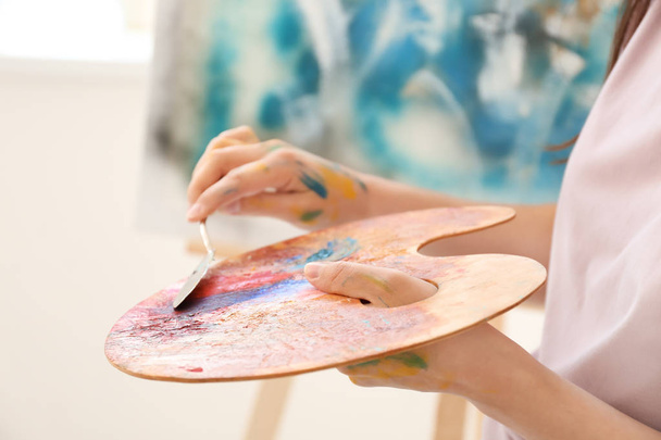 Female artist painting picture in workshop, closeup - Фото, зображення
