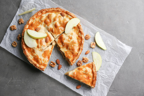 Tasty homemade apple pie on grey textured background - Photo, Image