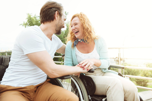 Radiant disabled people laughing hard outdoors - Fotoğraf, Görsel