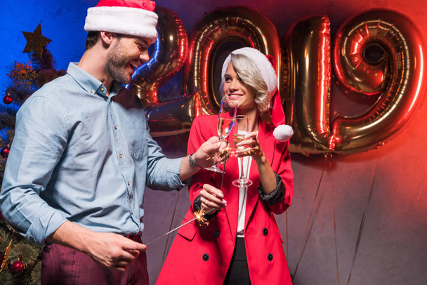молодые бизнесмены звонят с бокалами шампанского на новогодней корпоративной вечеринке
 - Фото, изображение