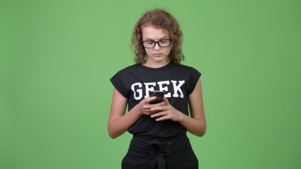 Young happy beautiful nerd woman using phone - Кадры, видео