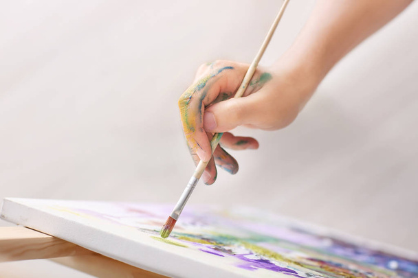 Male artist painting in workshop, closeup - Φωτογραφία, εικόνα