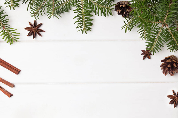 Fir branches and Christmas spices on the white wooden background - Foto, Bild