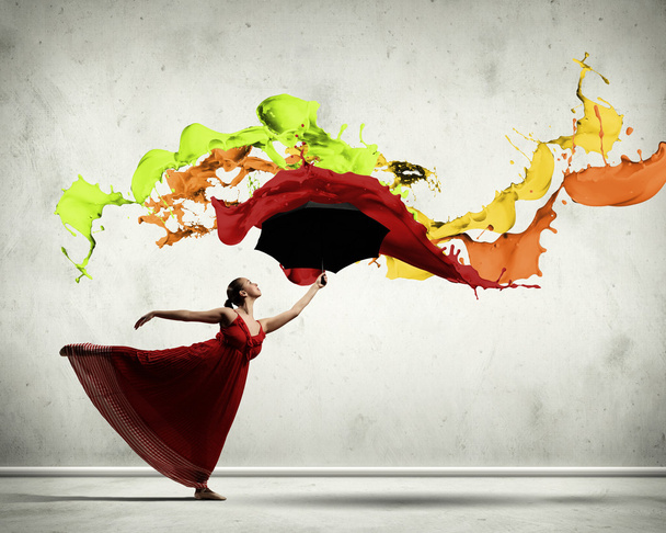 Ballet dancer in flying satin dress with umbrella - Foto, afbeelding