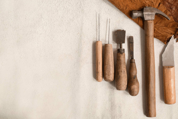 Craft tools for work with leather on light background - Photo, Image