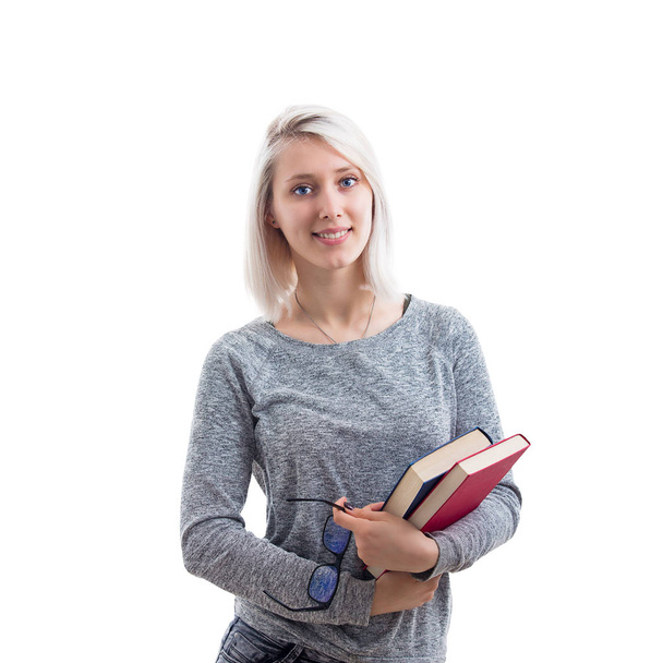 Donna sorridente studentessa, insegnante o donna d'affari che tiene libri in una mano e occhiali in un altro isolato su sfondo bianco
. - Foto, immagini