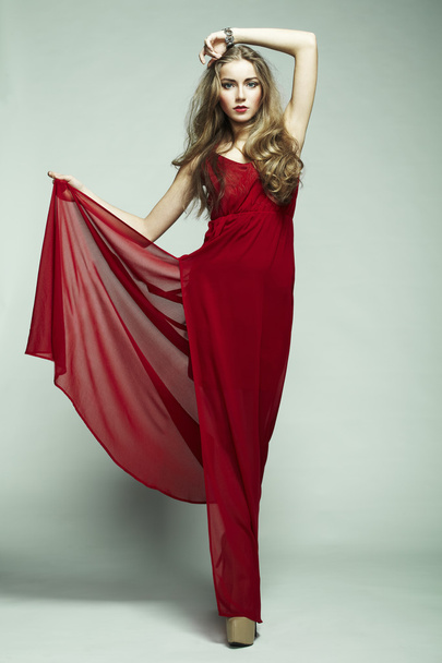 Fashion photo of young magnificent woman in red dress - Valokuva, kuva